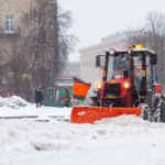 Small snow plow removing snow for bus stops in Waterloo, ON